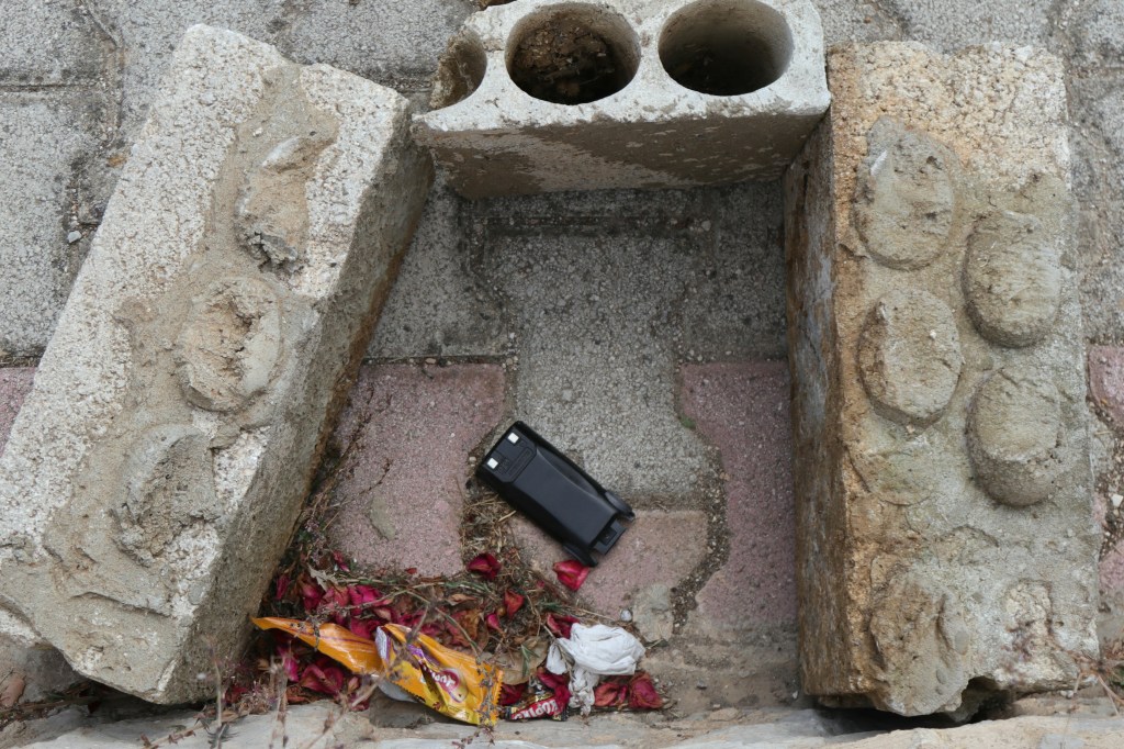 This picture shows a communication device on the ground as Lebanese forces (not in the piture) prepare to destroy it in a controlled explosion, in southern Lebanon between the villages of Burj al Muluk and Klayaa, on September 19, 2024.