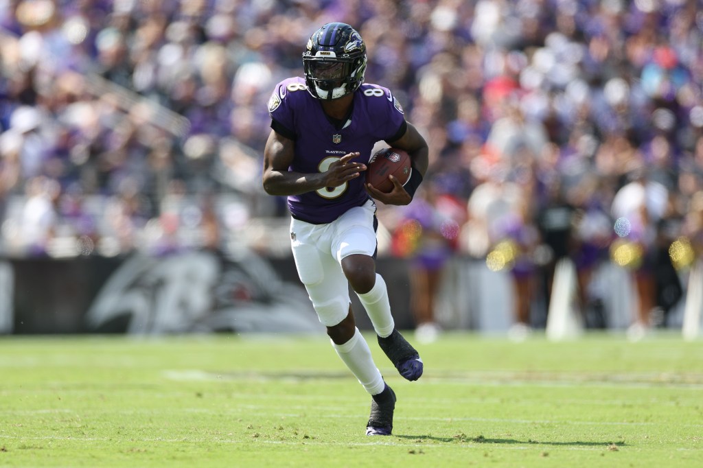 Lamar Jackson #8 of the Baltimore Ravens rushes with the ball against the Las Vegas Raiders.