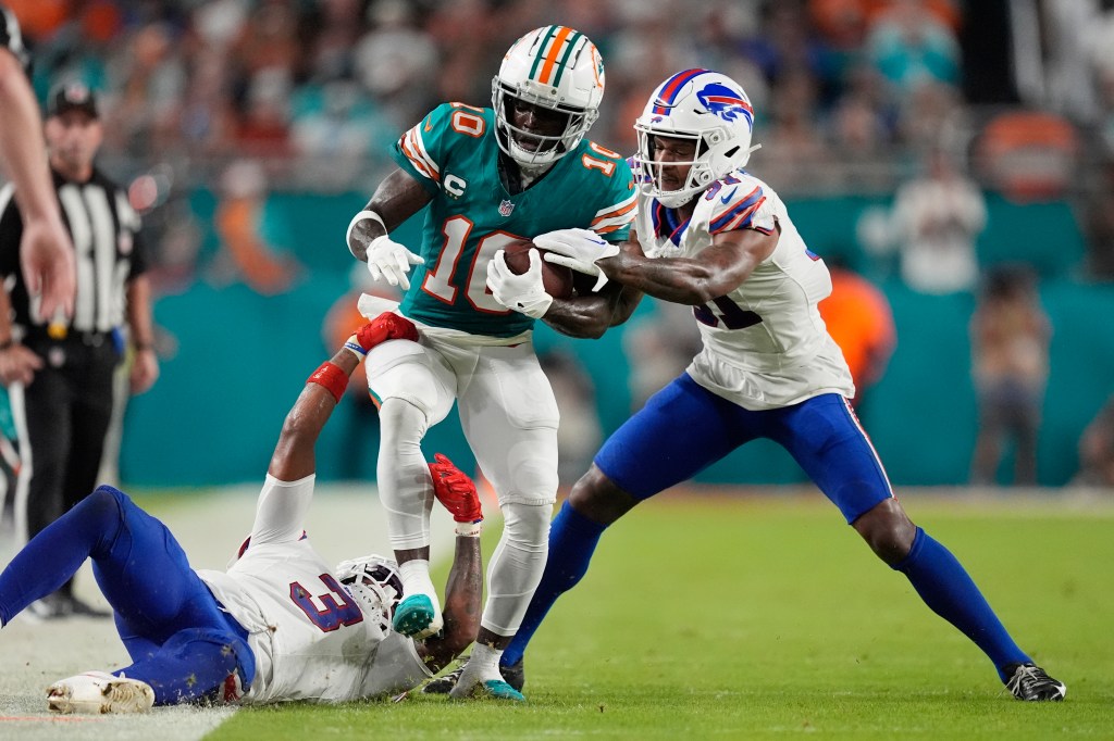 Buffalo Bills cornerback Rasul Douglas (31) and safety Damar Hamlin (3) stop Miami Dolphins wide receiver Tyreek Hill (10) during the first half of an NFL football game, Thursday, Sept. 12, 2024.