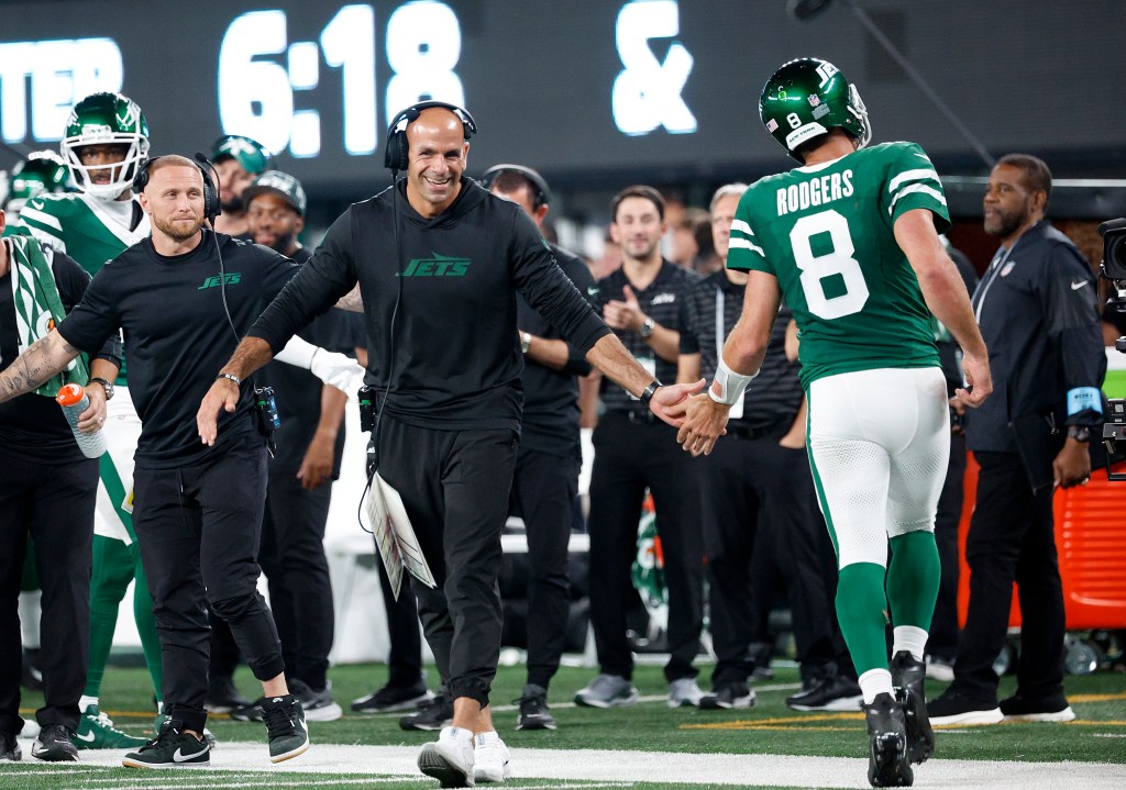 Aaron Rodgers #8 of the New York Jets celebrates with head coach Robert Saleh on the field after a touchdown