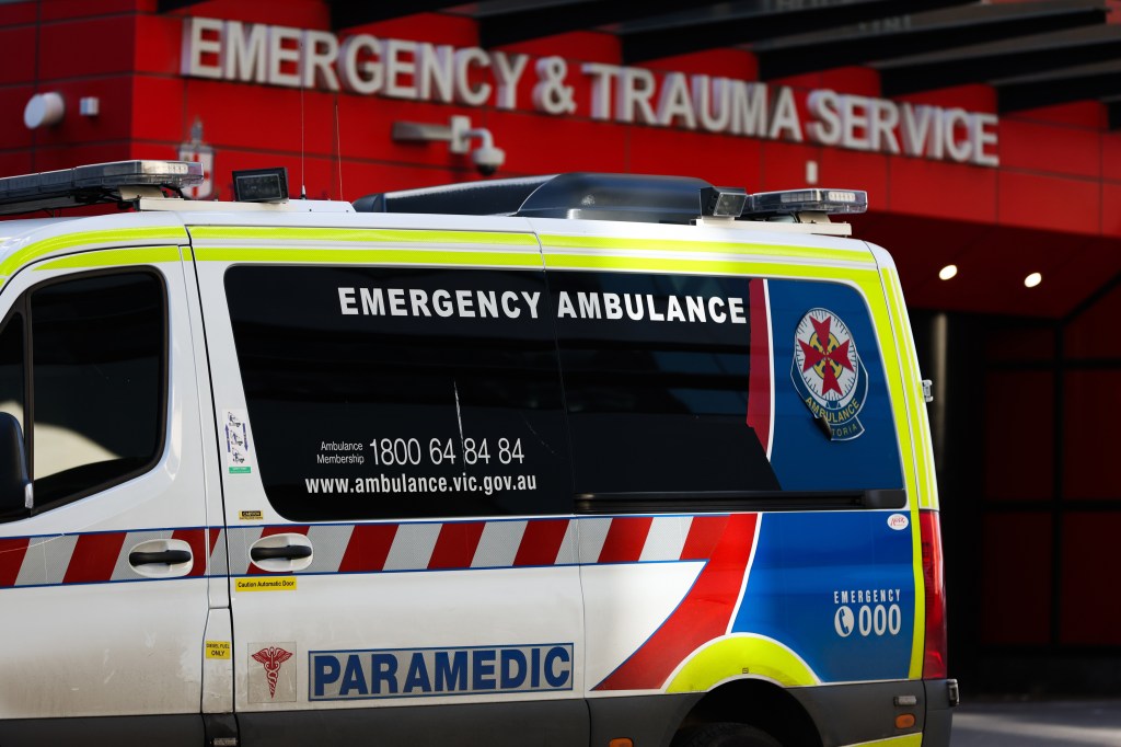 An ambulance parked in front of the Emergency & Trauma service at the Royal Melbourne Hospital in Melbourne, Australia amidst a rise in COVID-19 infections.