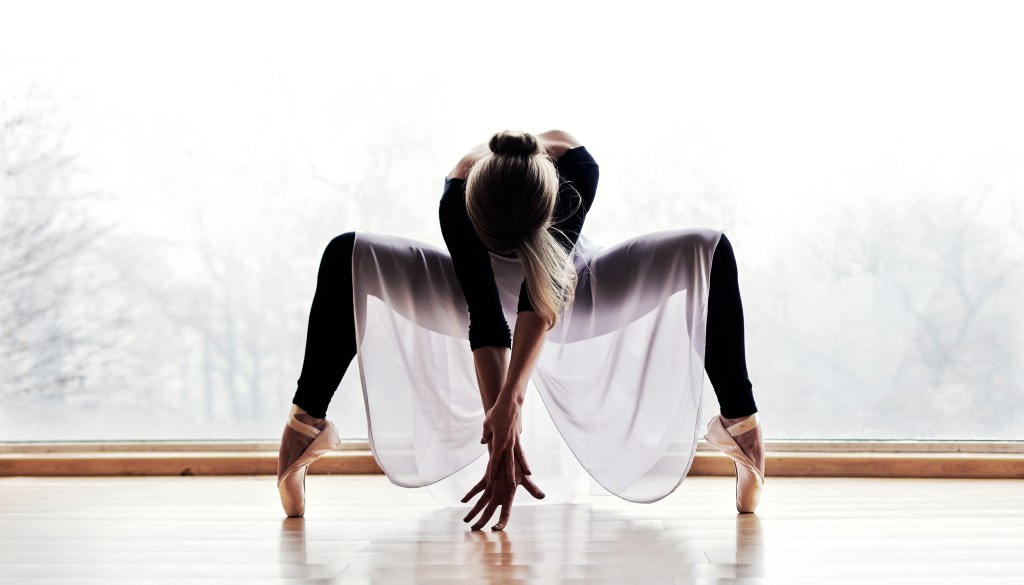 A woman in ballet outfit performing with fluidity, representing a Mars sign