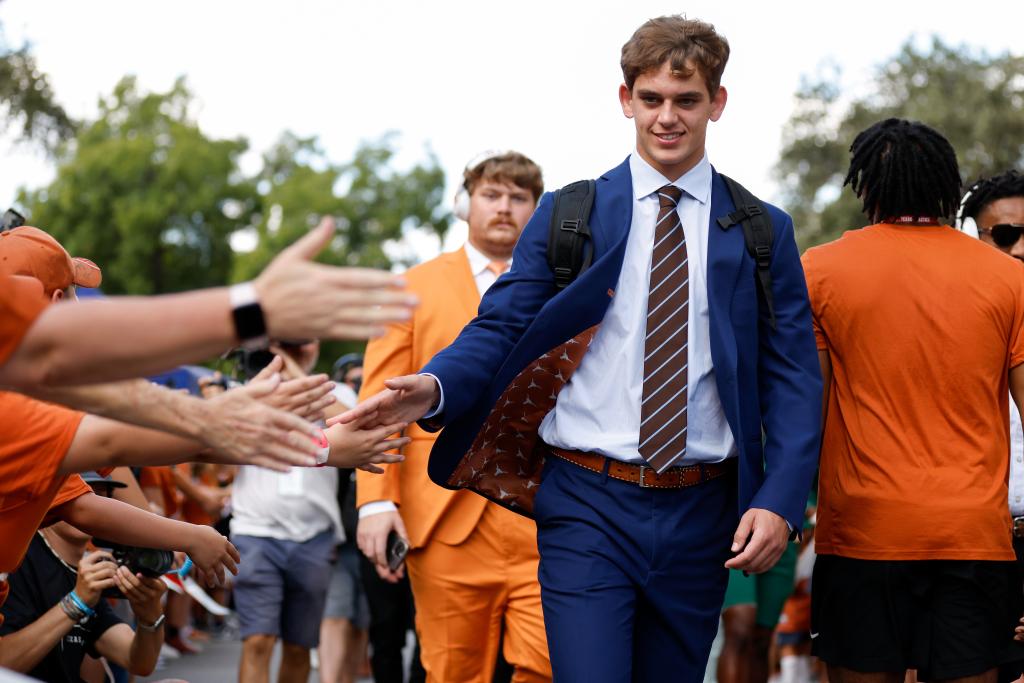 Arch Manning greets Texas fans as he enters the stadium before their game against UL-Monroe.