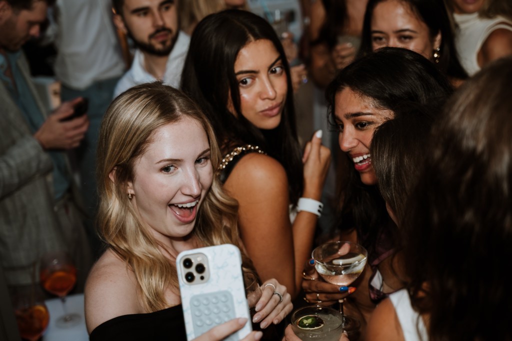 A group of women taking a selfie in an event for The League', photo courtesy of Margaryta Bushkin/Muccitas