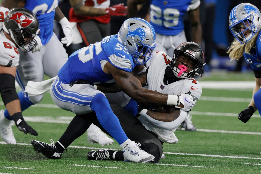 Detroit Lions linebacker Derrick Barnes (55) tackles Tampa Bay Buccaneers running back Bucky Irving (7) during the first half of an NFL football game, Sunday, Sept. 15, 2024, in Detroit.