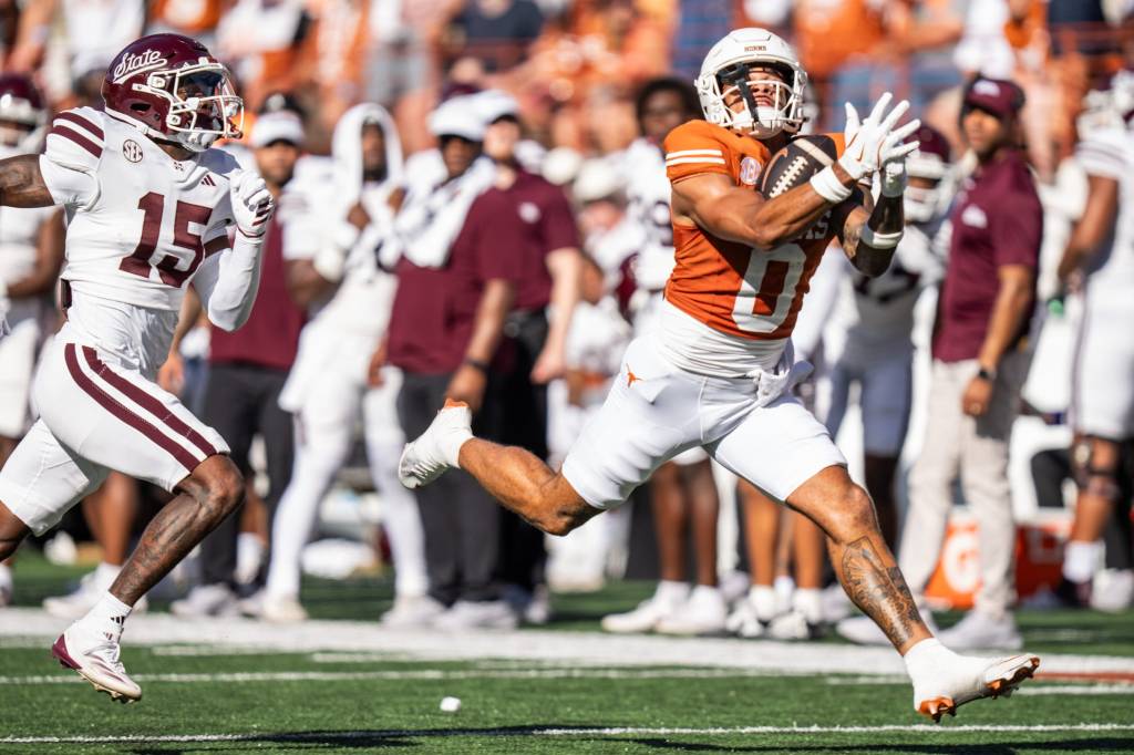 DeAndre Moore catches a 49-yard touchdown pass from Arch Manning during the first half of Texas' win.