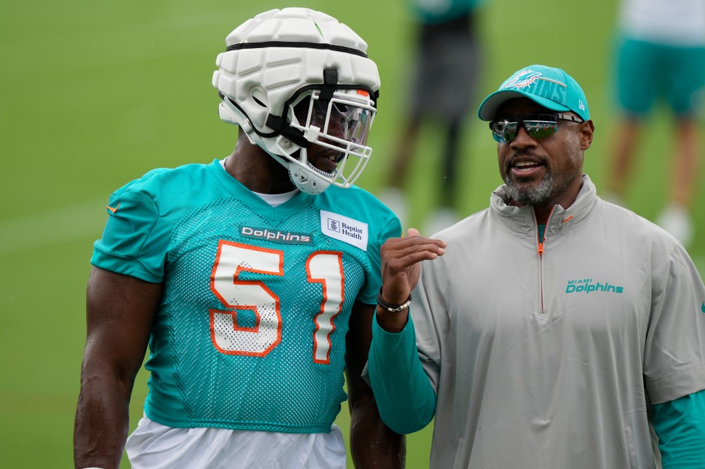 Miami Dolphins linebacker Emmanuel Ogbah (51) talks with defensive coordinator Anthony Weaver, right, during NFL football training camp, Wednesday, July 24, 2024, in Miami Gardens, Fla. 