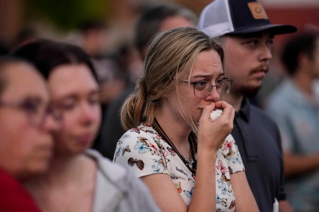 Mourners pray during a candlelight vigil for the slain students and teachers at Apalachee High School, Wednesday, Sept. 4, 2024, in Winder, Ga.