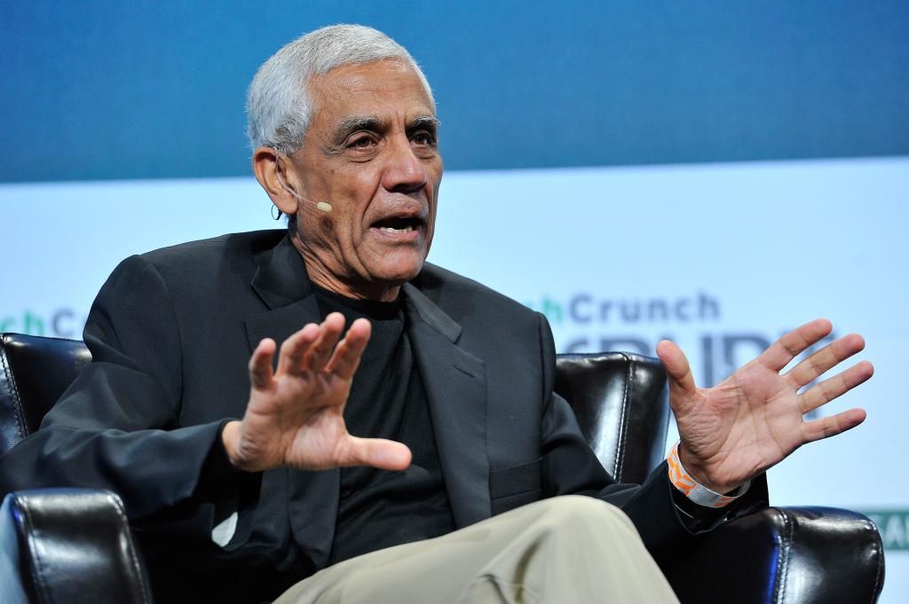 Vinod Khosla of Khosla Ventures speaking onstage at TechCrunch Disrupt SF 2015 in San Francisco, gesturing with his hands while sitting in a chair.