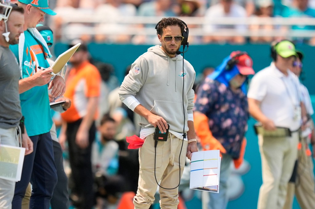 Miami Dolphins head coach Mike McDaniel watches the game from the sidelines during the first half of an NFL football game against the Jacksonville Jaguars, Sunday, Sept. 8, 2024, in Miami Gardens, Fla.