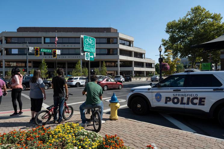 People watch as Springfield Police Department officers investigate the Springfield City Hall after bomb threats were made against buildings earlier in the day in Springfield, Ohio on September 12, 2024.