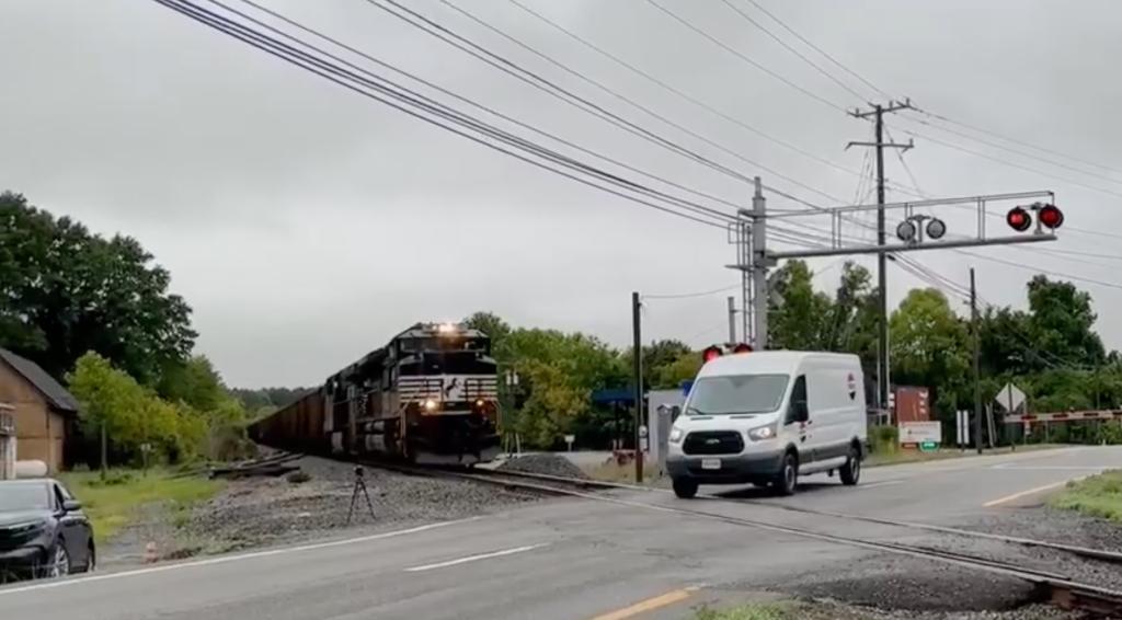 The video shows the Pepsi van driving toward the crossing before slamming on the brakes and bumping into the arm of the gate.