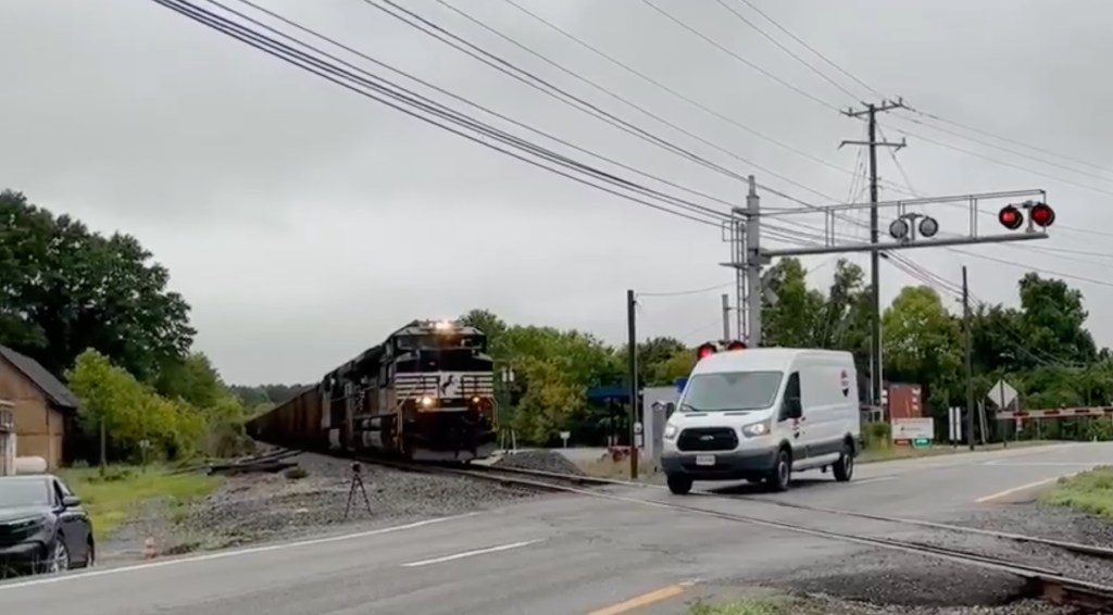 The video shows the Pepsi van driving toward the crossing before slamming on the brakes and bumping into the arm of the gate.