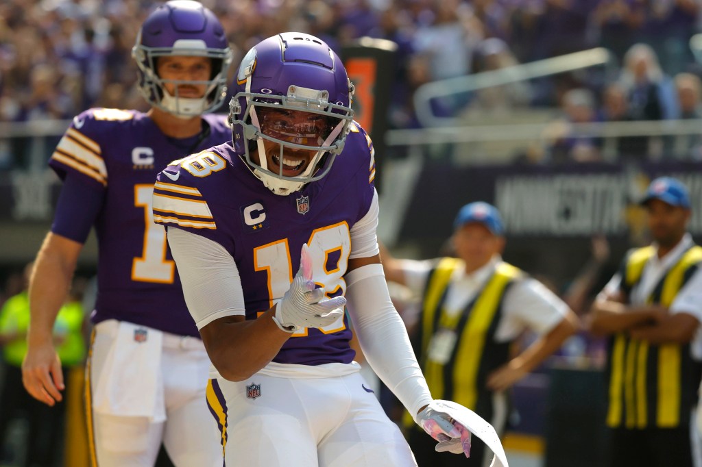 Justin Jefferson celebrates after catching a touchdown pass during the first half.