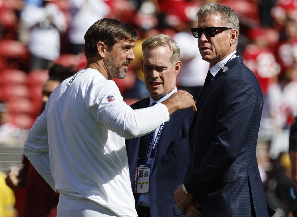 ESPN's Troy Aikman (right) and Joe Buck (center) talk with Aaron Rodgers before the Jets' Week 1 loss to the 49ers.