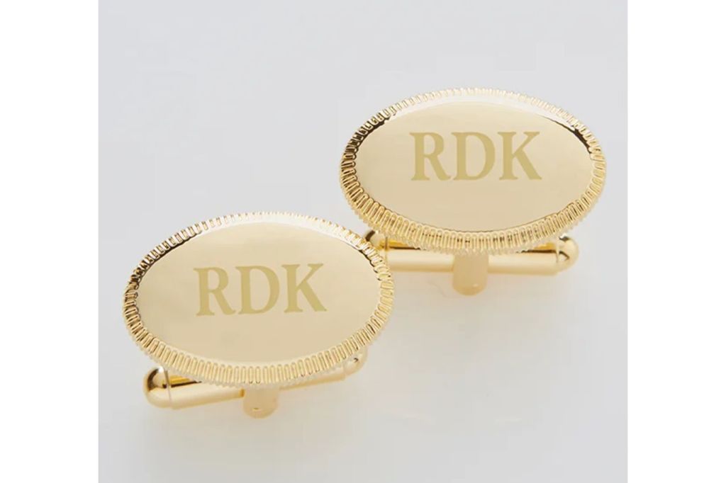 A pair of gold cufflinks engraved.