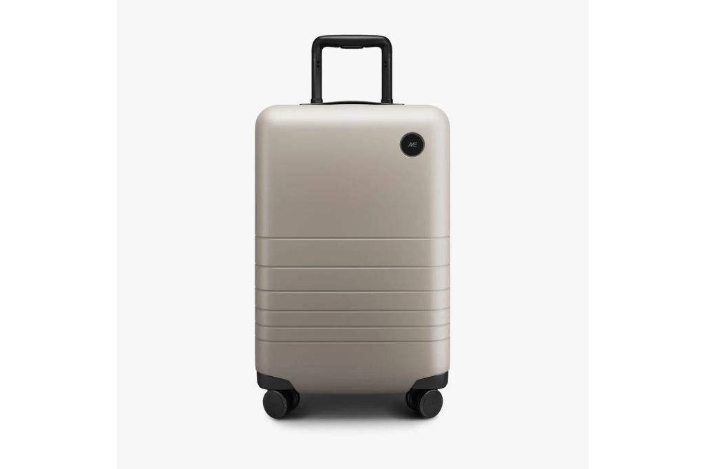 A silver carry-on suitcase.