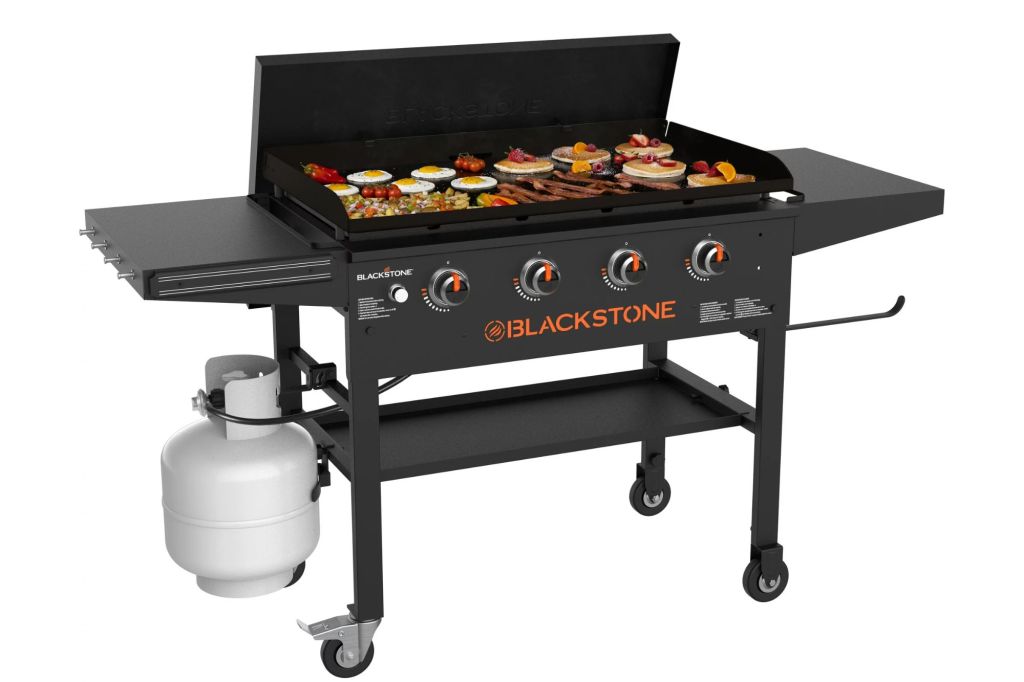 A large grill with pancakes and other foods inside.