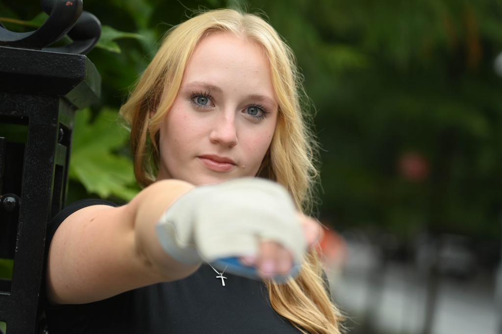 Alexa Very holds up her right hand, which has a splint on it, while posing in Washington Square Park this week 