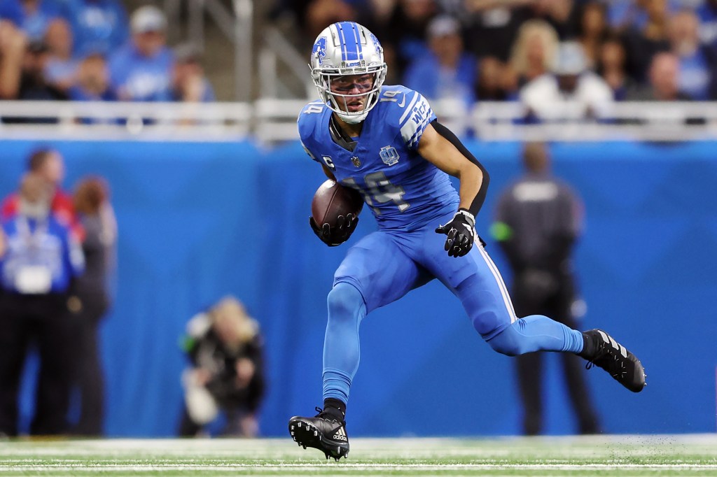 Amon-Ra St. Brown #14 of the Detroit Lions runs with the ball during a game against the Atlanta Falcons