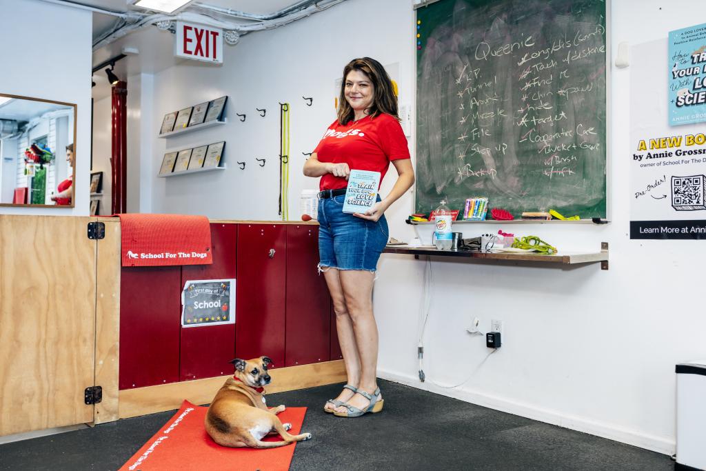 Annie Grossman training her dog, Poppy, to sit and stay on a half-sized yoga mat at School For the Dogs in the East Village, Manhattan