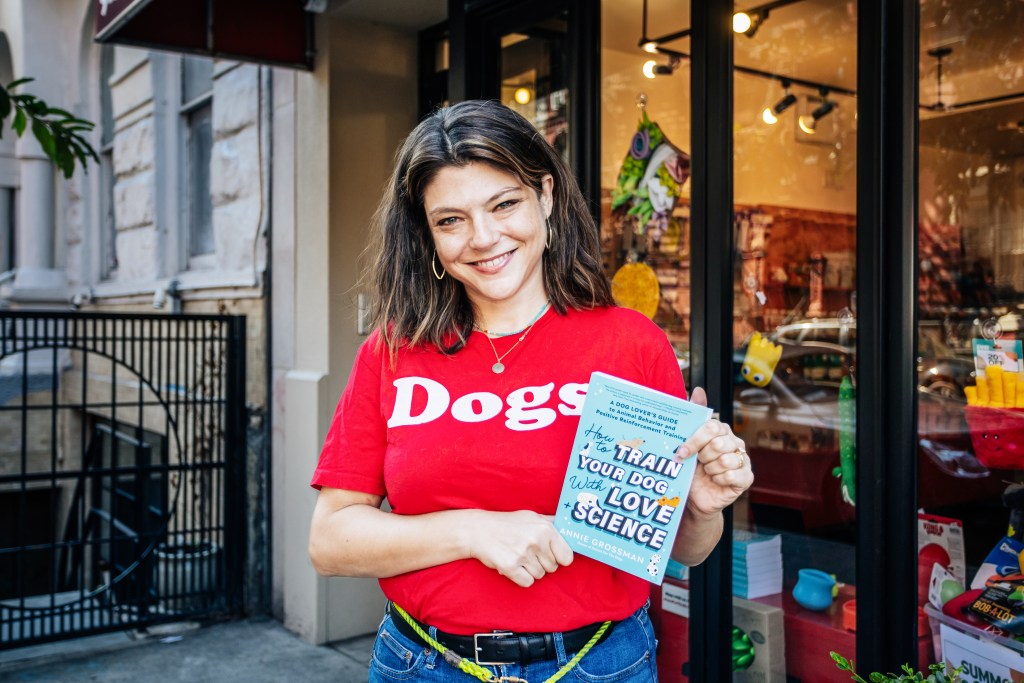 Annie Grossman holding a book at School For the Dogs in the East Village, Manhattan, photographed by Emmy Park.