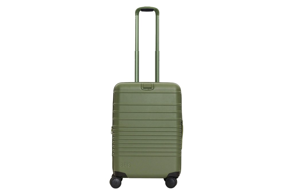 A green suitcase with wheels