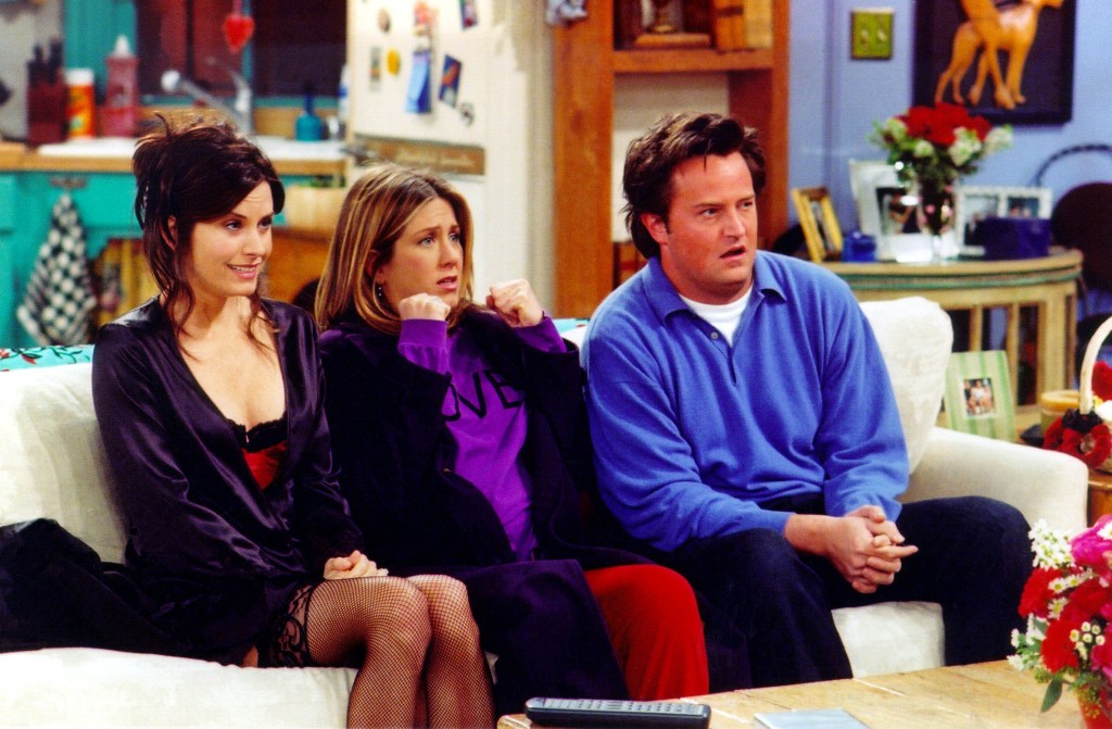 Courteney Cox, Jennifer Aniston and Matthew Perry are shown in a scene from the NBC series "Friends."