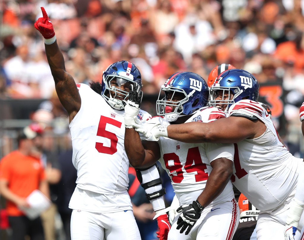 Giants Elijah Chatman (94) celebrates his sack on Cleveland Browns quarterback Deshaun Watson (4) in the first half with Kayvon Thibodeaux (5) and Dexter Lawrence II (57)