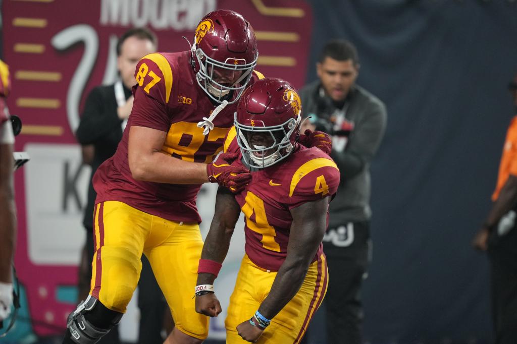 Trojans running back Woody Marks (4) celebrates with tight end Lake McRee (87) after scoring on a 13-yard touchdown run with eight seconds left against the LSU Tigers at Allegiant Stadium.