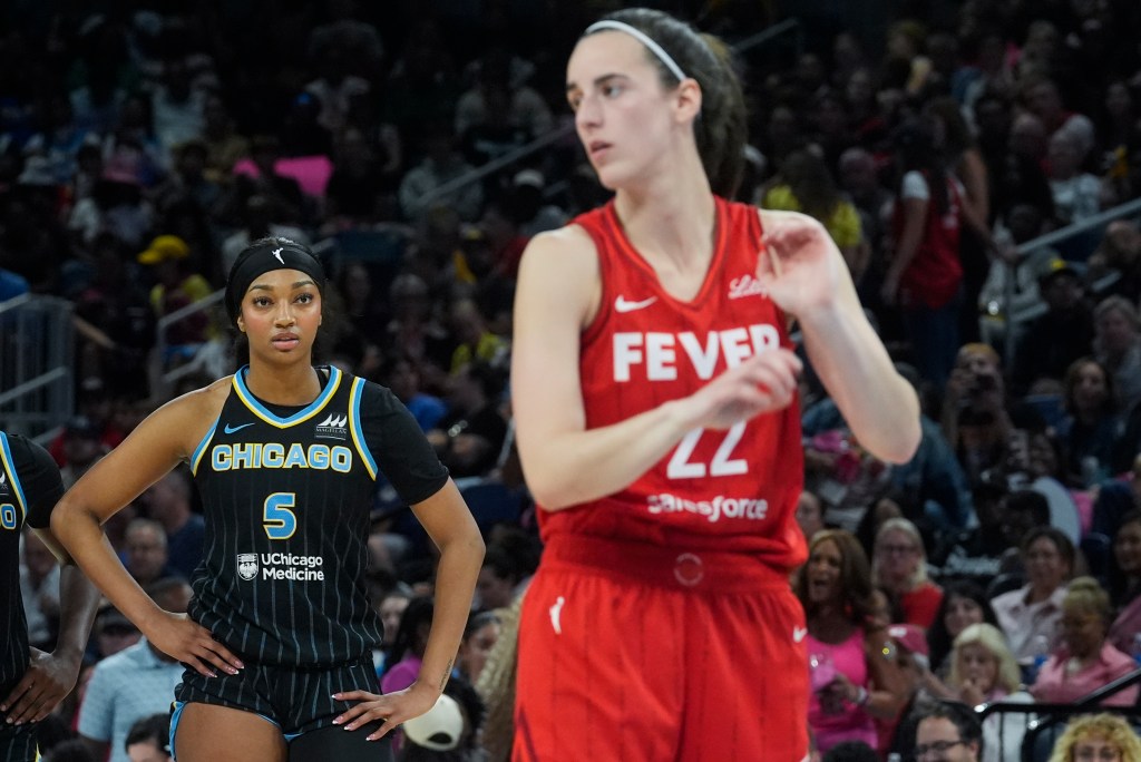 Chicago Sky forward Angel Reese, left, watches Indiana Fever guard Caitlin Clark take a free throw during the second half of a WNBA basketball game Friday, Aug. 30, 2024, in Chicago. 