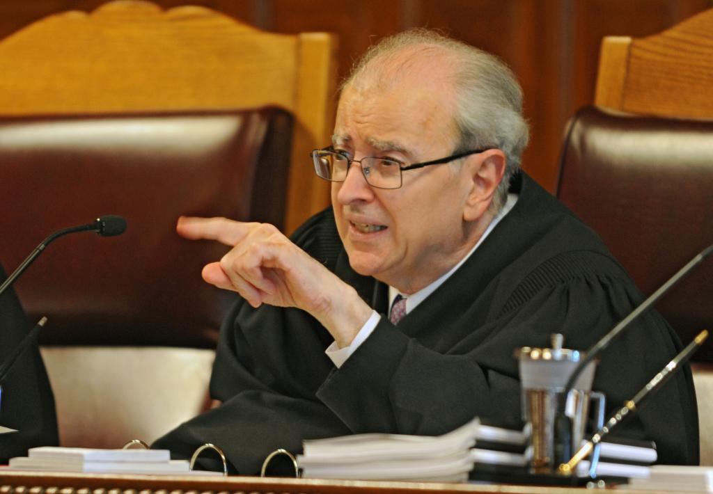 State Chief Judge Jonathan Lippman talks to an attorney during arguments over a civilly confined sex predator, who was confined under what lawyers say is improper diagnosis at the New York Court of Appeals on Thursday, Sept. 18, 2014.