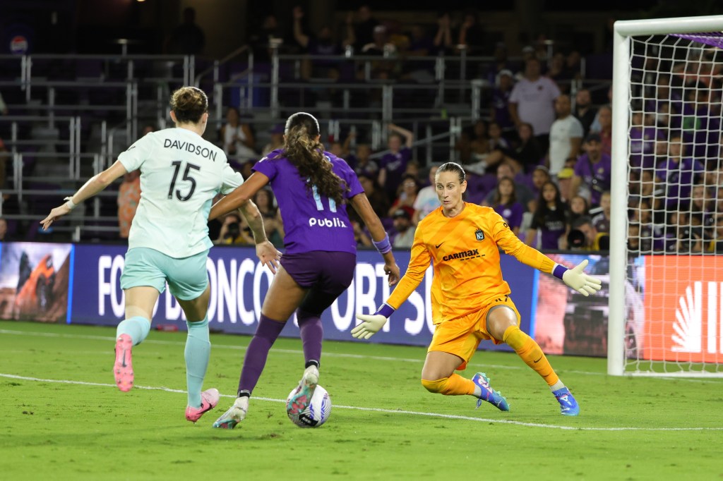 NJ/NY Gotham FC goalkeeper Ann-Katrin Berger and defender Tierna Davidson defending against Orlando Pride forward Ally Watt in a football match