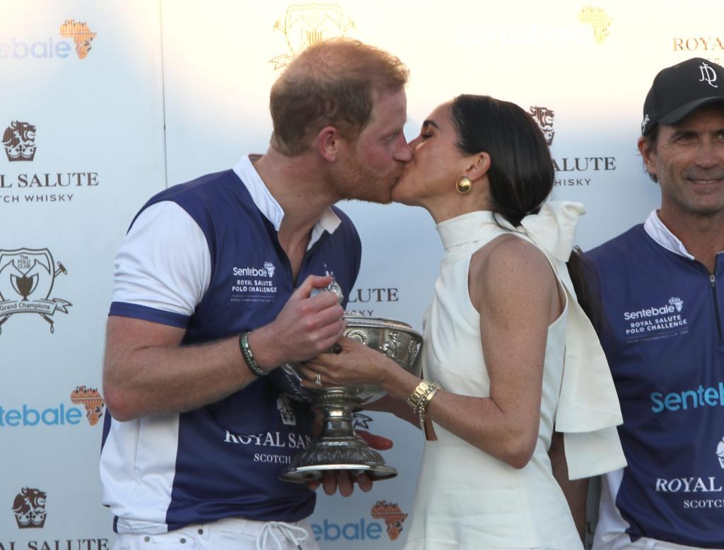 Duchess of Sussex presenting trophy to Duke of Sussex at Royal Salute Polo Challenge in Florida