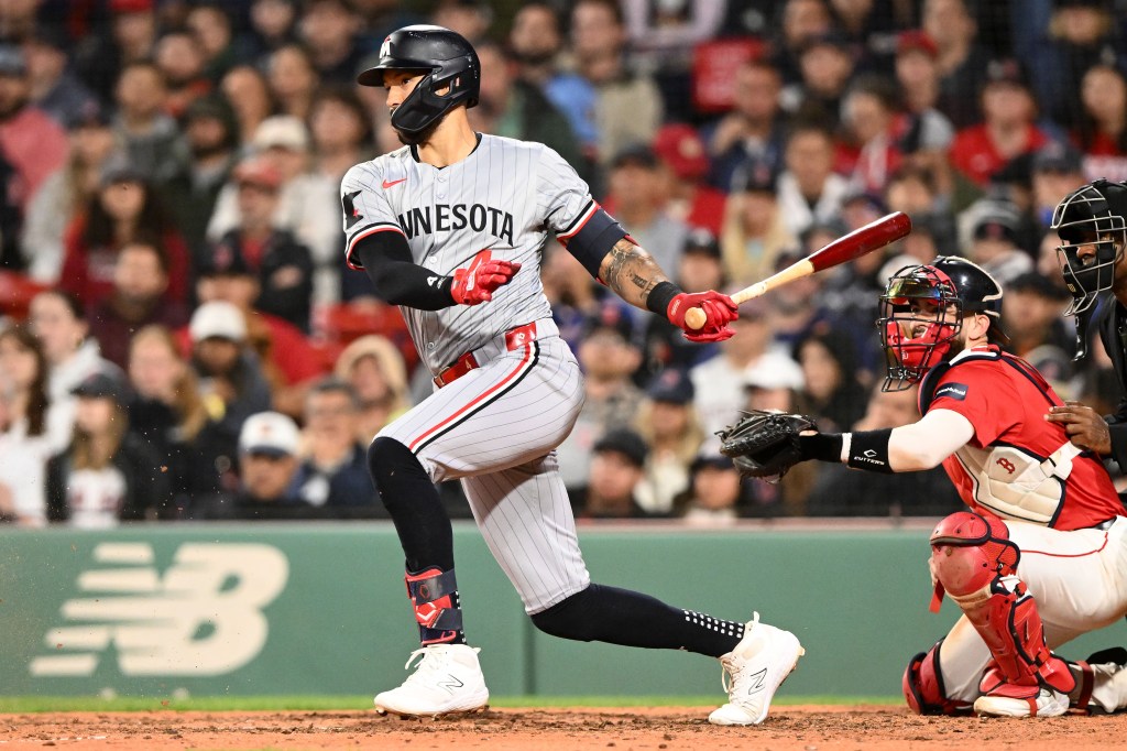 Minnesota Twins shortstop Carlos Correa (4) hits a RBI against the Boston Red Sox during the seventh inning at Fenway Park.