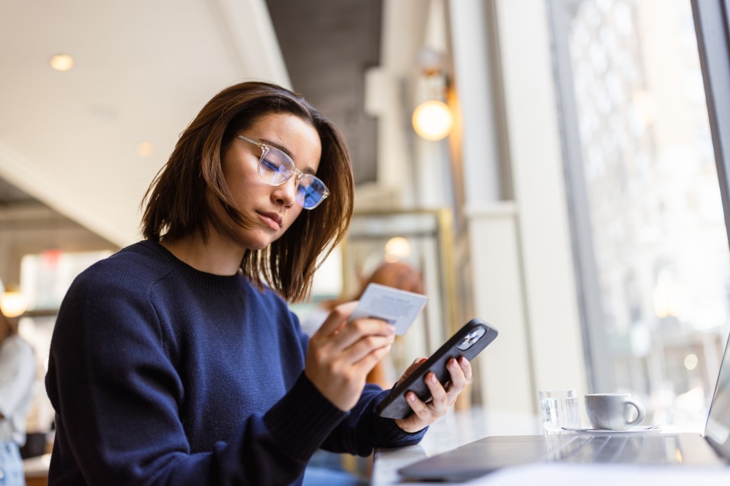 student enjoys the seamless experience of online shopping while relaxing in a Soho café.