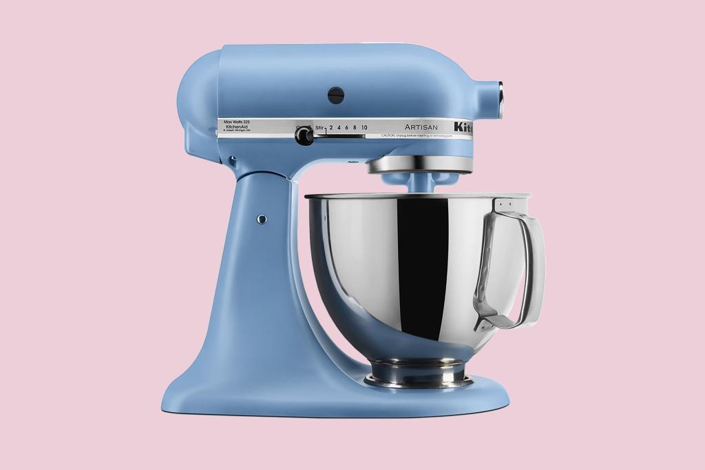 Eva Longoria standing next to a blue mixer with a bowl