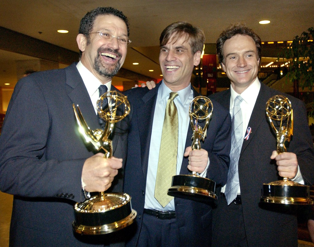 Executive Producers Thomas Schlamme, left, and Aaron Sorkin, center, are joined by actor Bradley Whitford as they celebrate their Emmy awards for their work on "The West Wing" following the 53rd annual Primetime Emmy Awards at the Shubert Theatre in Los Angeles, Nov. 4, 2001.