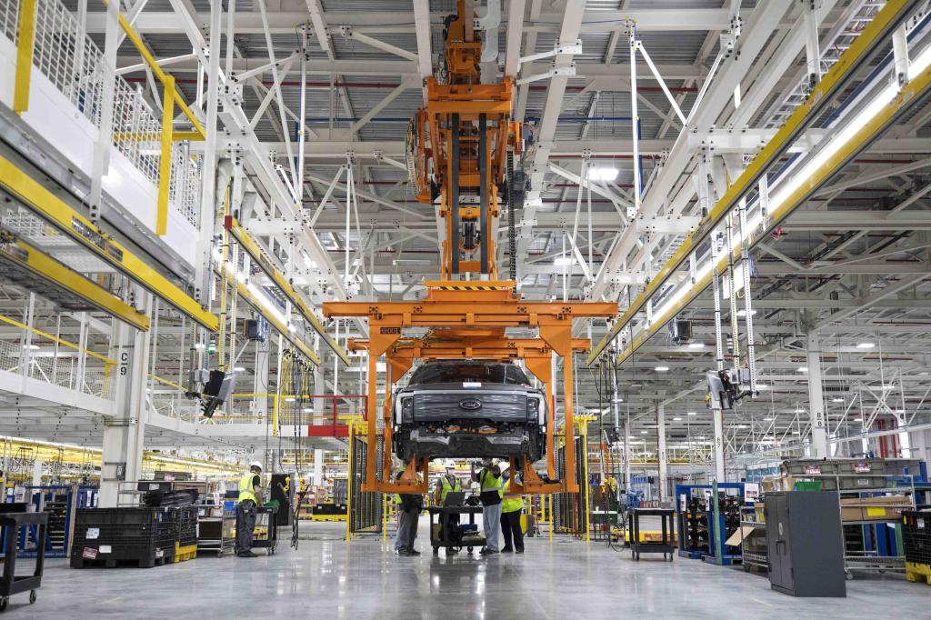 People working on the production of an all-electric Ford F-150 Lightning pickup truck at the Ford Rouge Electric Vehicle Center in Dearborn, Michigan.
