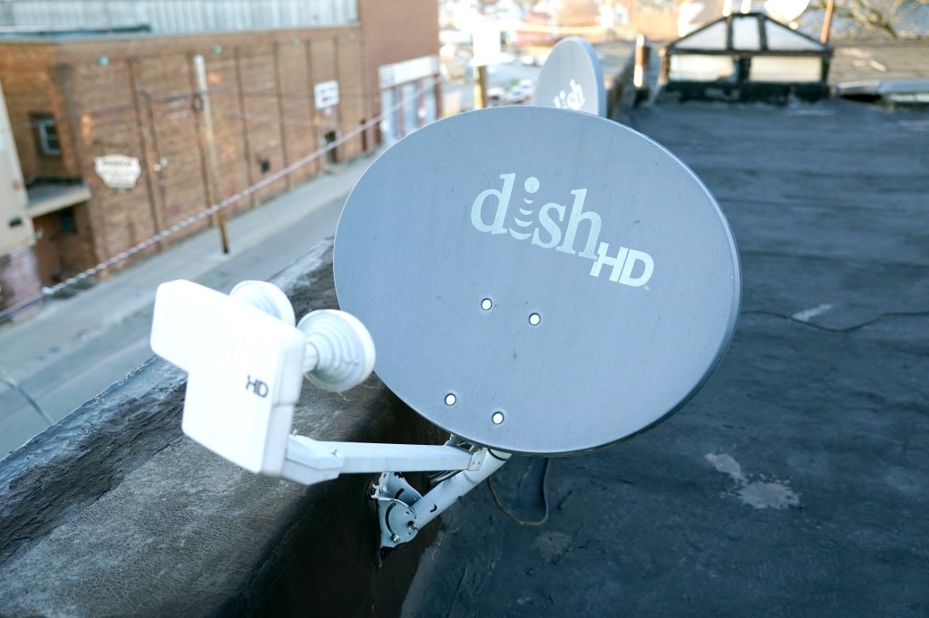 A Dish Network satellite dish mounted on a rooftop.