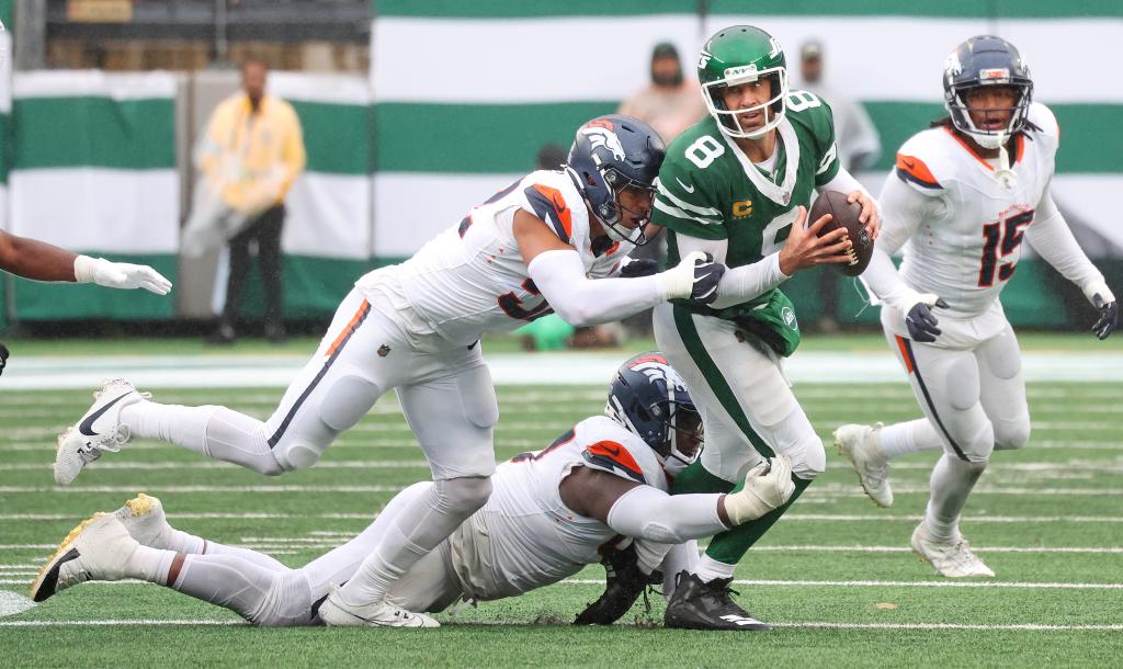 New York Jets quarterback Aaron Rodgers (8) gets sacked late in the fourth quarter when the New York Jets played the Denver Broncos Sunday, September 29, 2024 at MetLife Stadium in East Rutherford, NJ. New York Jets lost 10-9. 