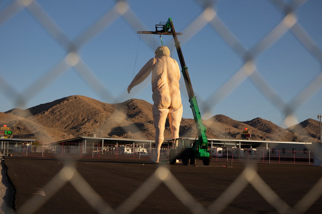 Gigantic foam and rebar statue resembling former President Donald Trump being displayed in a fenced lot near Las Vegas, Nevada