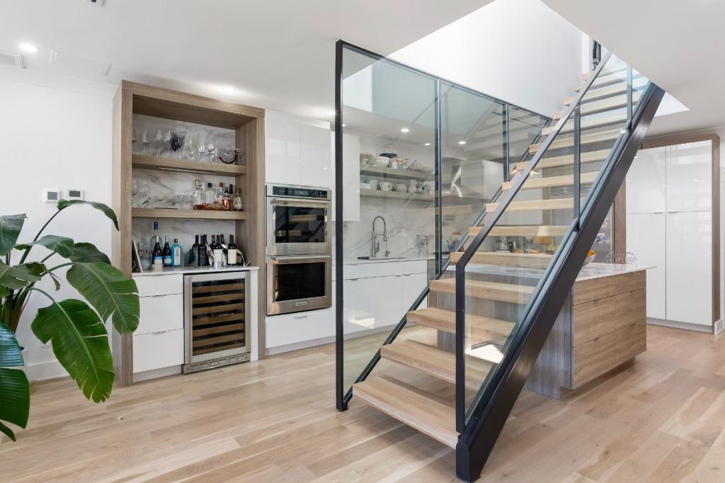 Stairs lead to a main bedroom suite and a private 900 square foot rooftop terrace