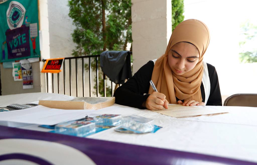 Haneen Jaber, who will turn 18 this October, fills out a voter registration form during an event run as a part of National Muslim Voter Registration Day, held at the Muslim Society of Memphis.