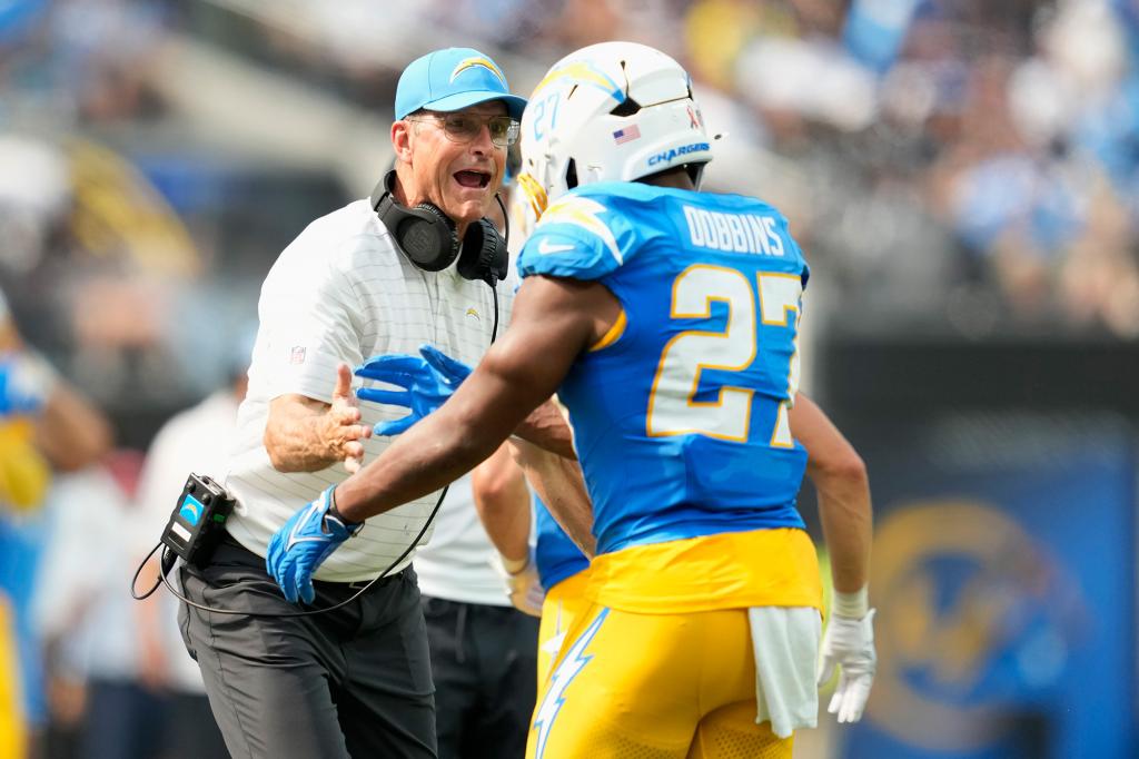 Jim Harbaugh and J.K. Dobbins celebrate during the Chargers' game on Sept. 8.