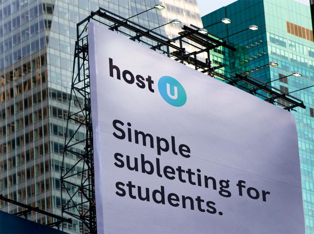 Billboard sign featuring blue and black text promoting hostU, a company that has raised millions of dollars since its launch in April 2023