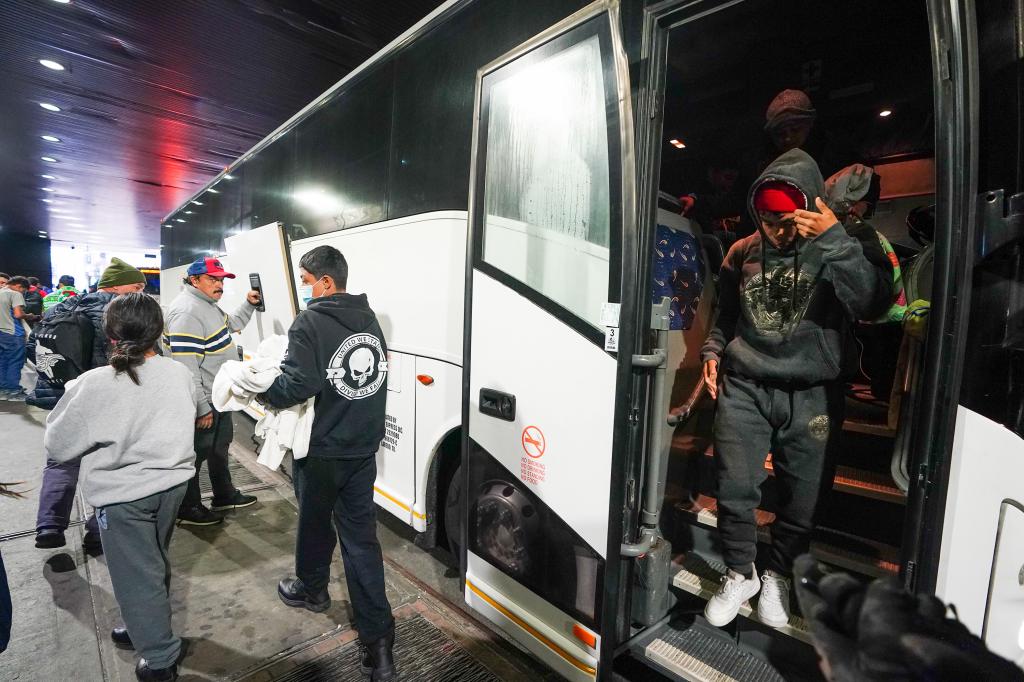 Migrants departing a bus in the Port Authority bus terminal on Dec. 21, 2023.