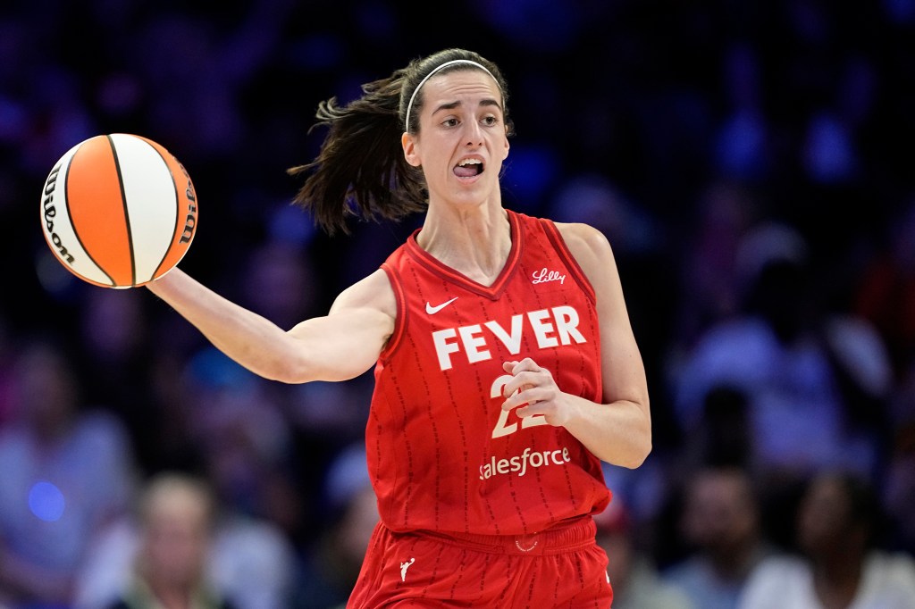 Indiana Fever's Caitlin Clark makes a long pass upcourt.