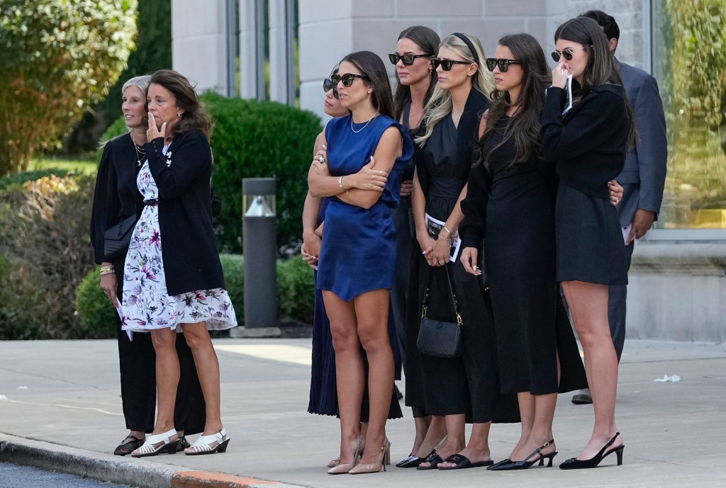 Sep 9, 2024; Media, Pennsylvania, USA;  Jane Gaudreau, second from left, and Meredith Gaudreau, middle in blue, watch with friends and family as a hearse carries away the casket Johnny Gaudreau following his funeral at St. Mary Magdalen Parish. 