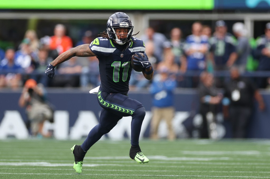 Jaxon Smith-Njigba #11 of the Seattle Seahawks runs with the ball